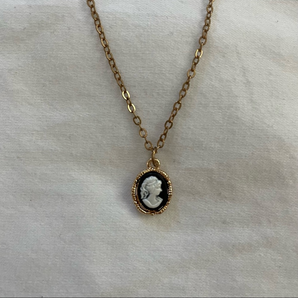 gold-chained pendent with a unique navy and white middle